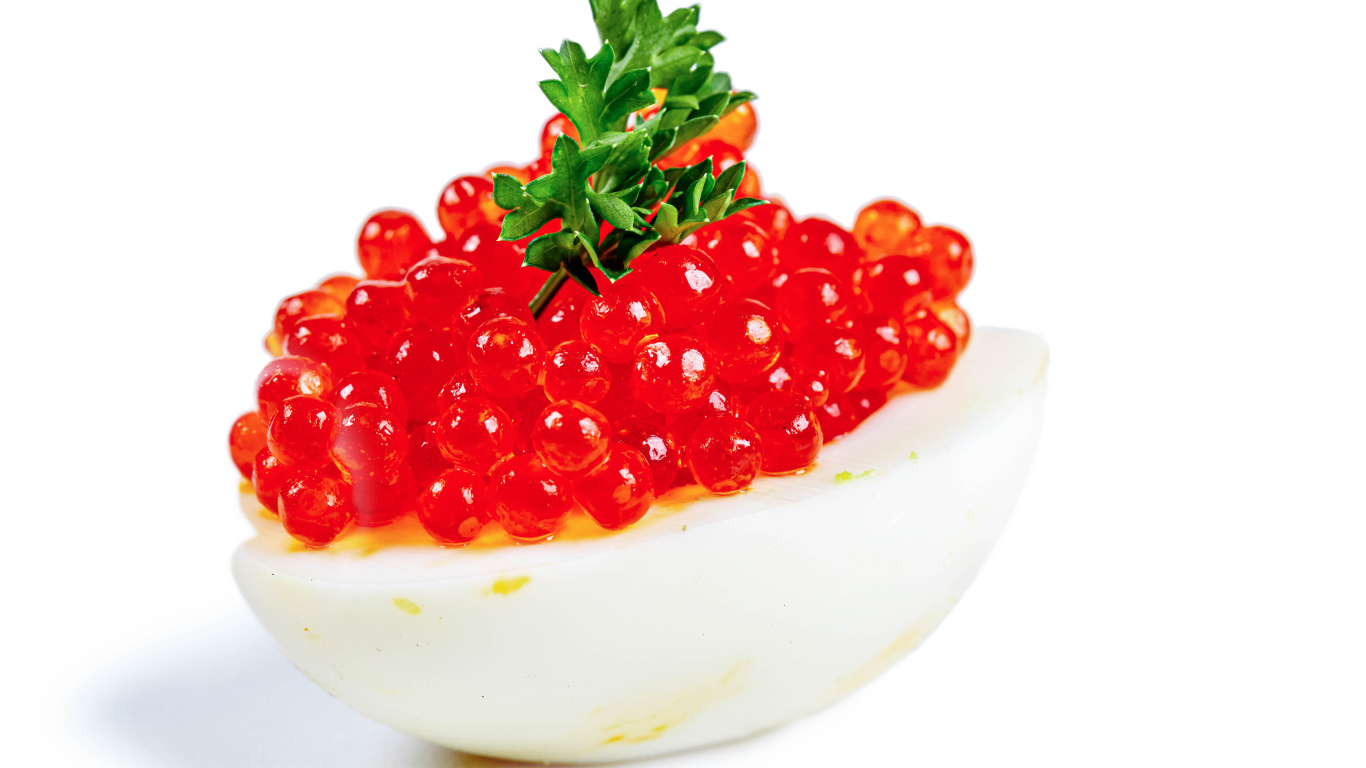 Яйцо фаршированное красной икрой на белом фоне