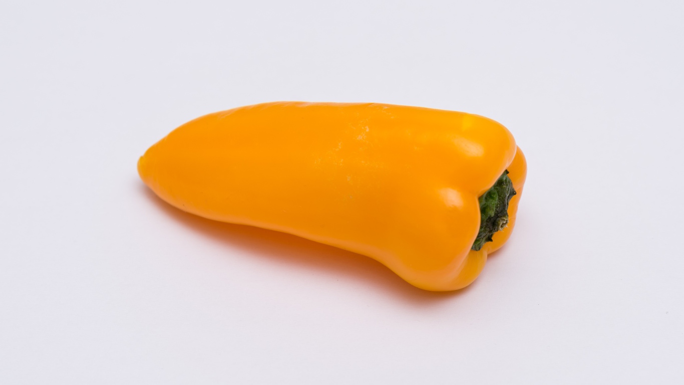 Желтый болгарский перец на сером фоне