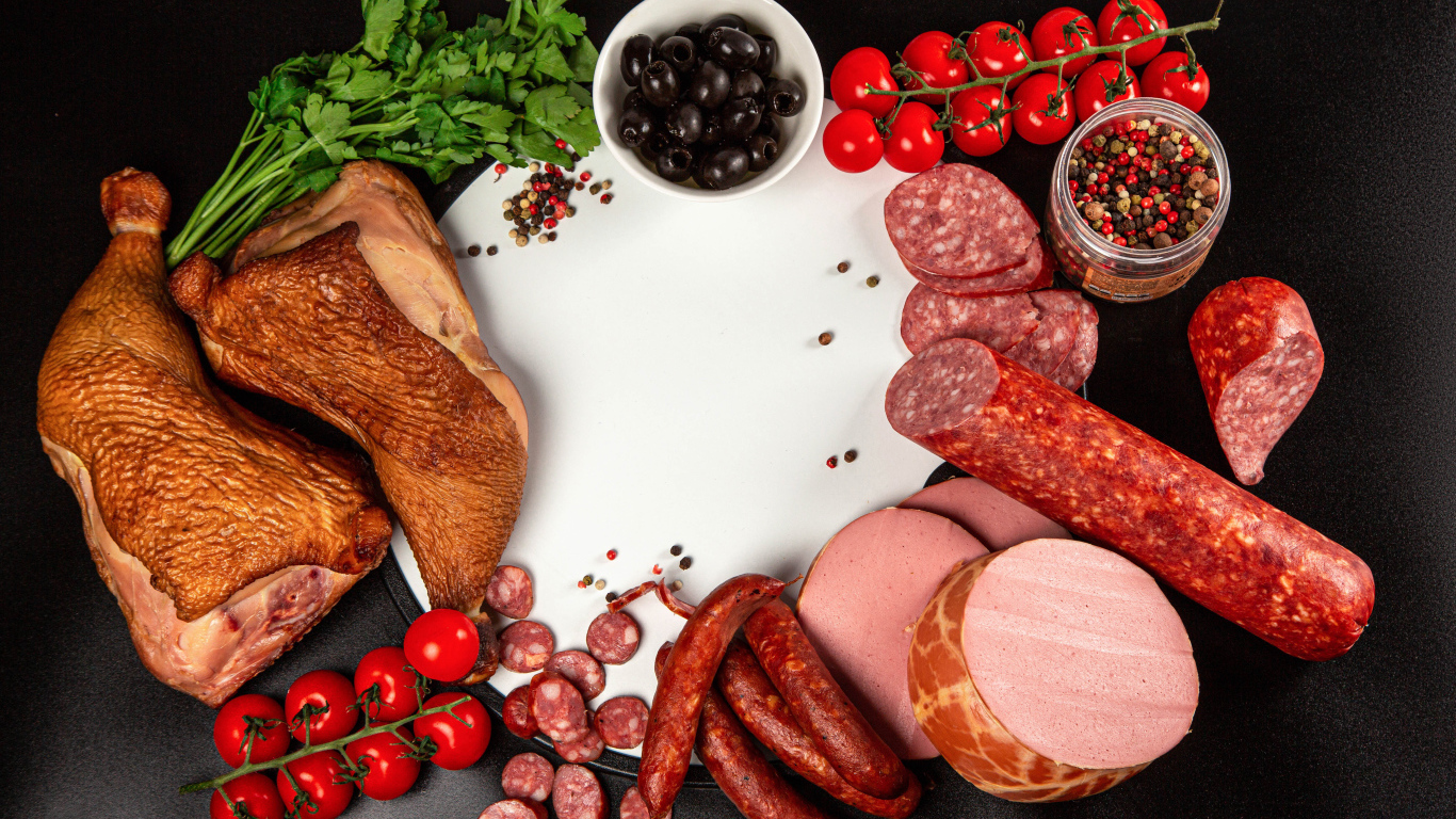 Smoked meats on the table with spices and tomatoes