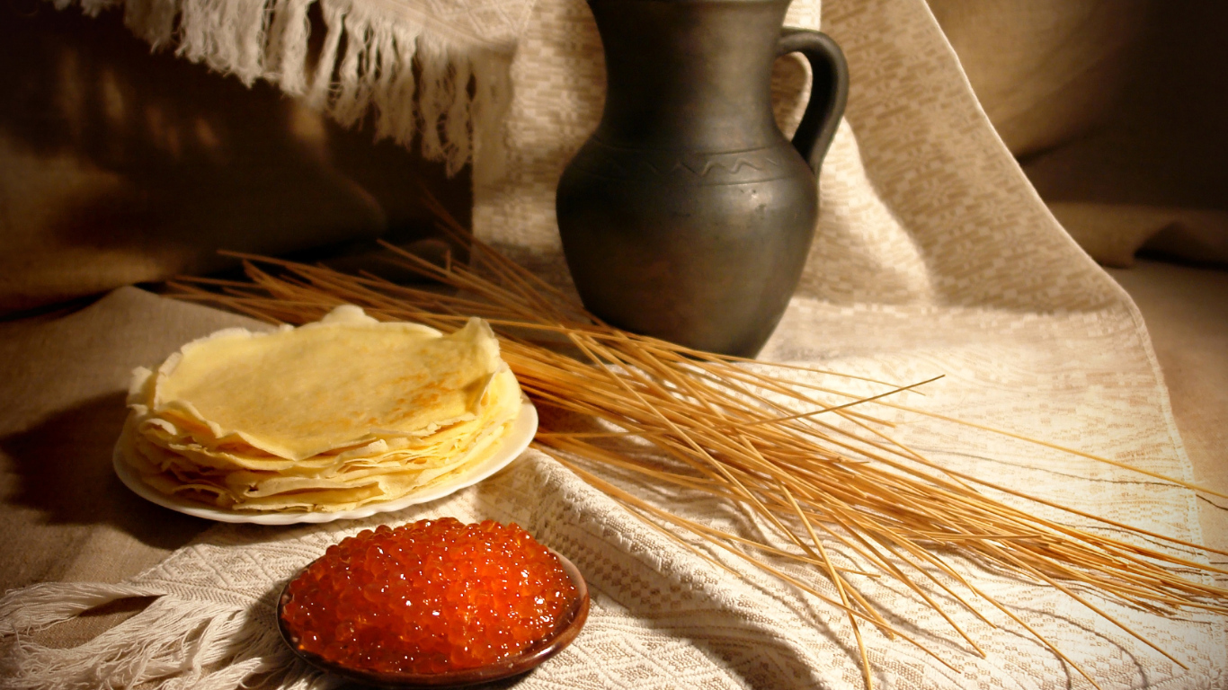 Блины с икрой на столе с колосьями на праздник Масленица