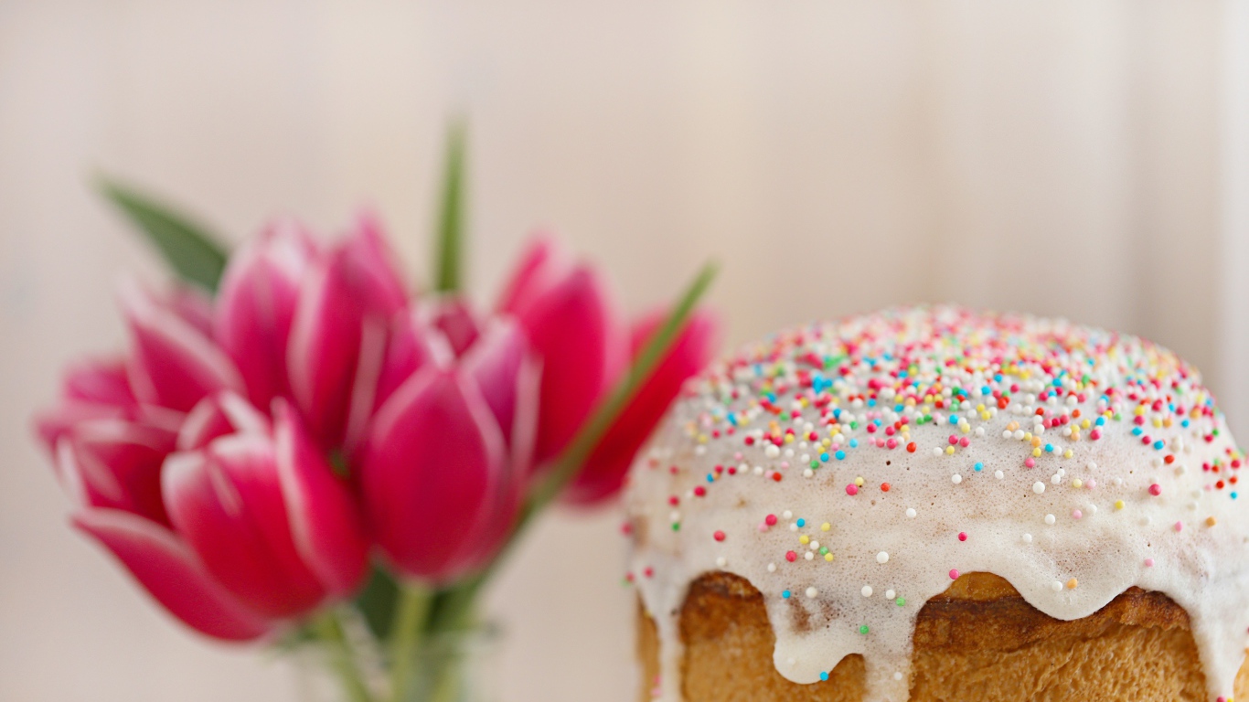 Пасхальный кулич с белой глазурью с букетом тюльпанов