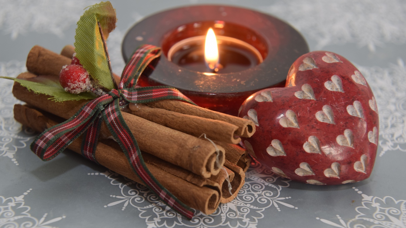 Cinnamon, candle and heart on the table