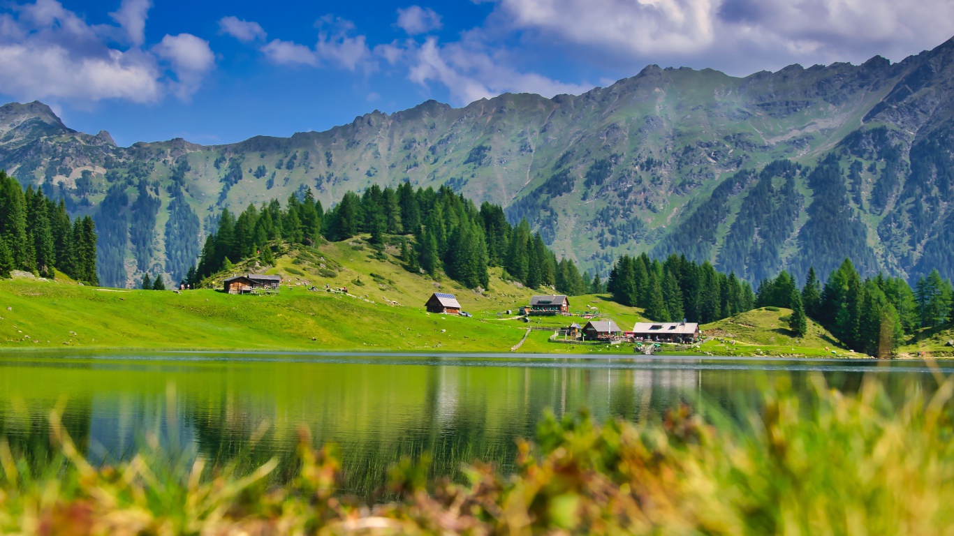 Красивый пейзаж на горы и озеро и зеленые луга