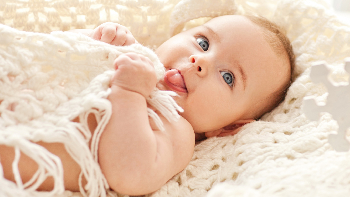 Забавный грудной ребенок с высунутым языком