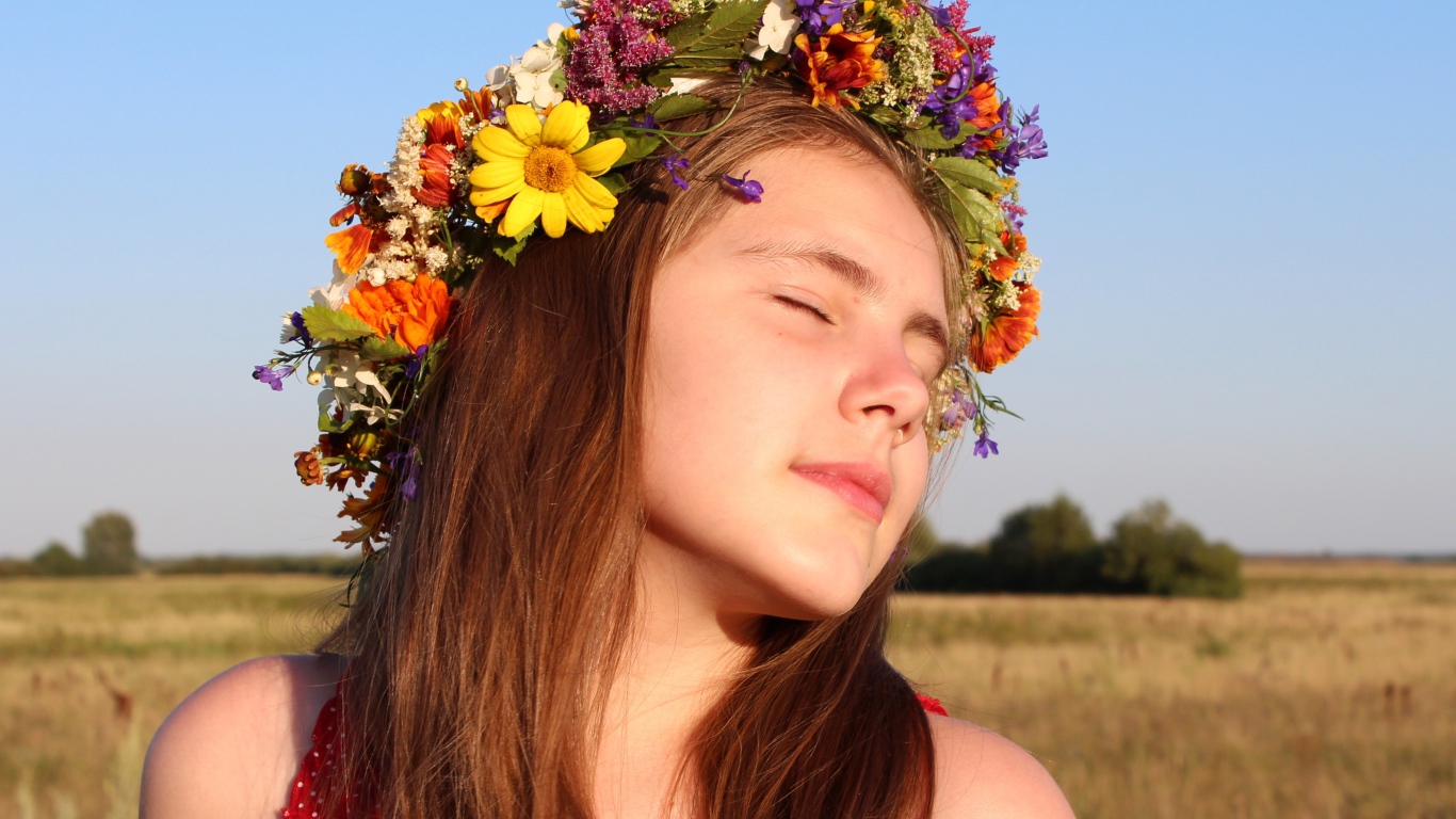 Girl with closed eyes with a wreath on her head