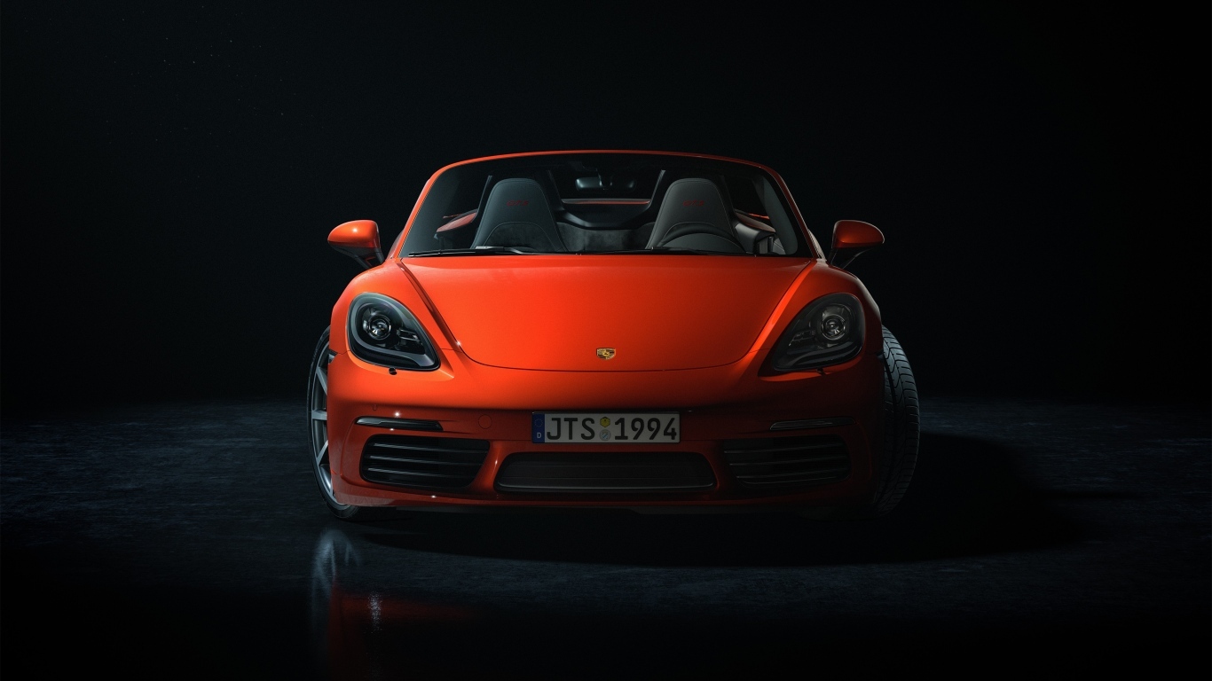 Красный автомобиль Porsche 911 CGI  вид спереди на черном фоне