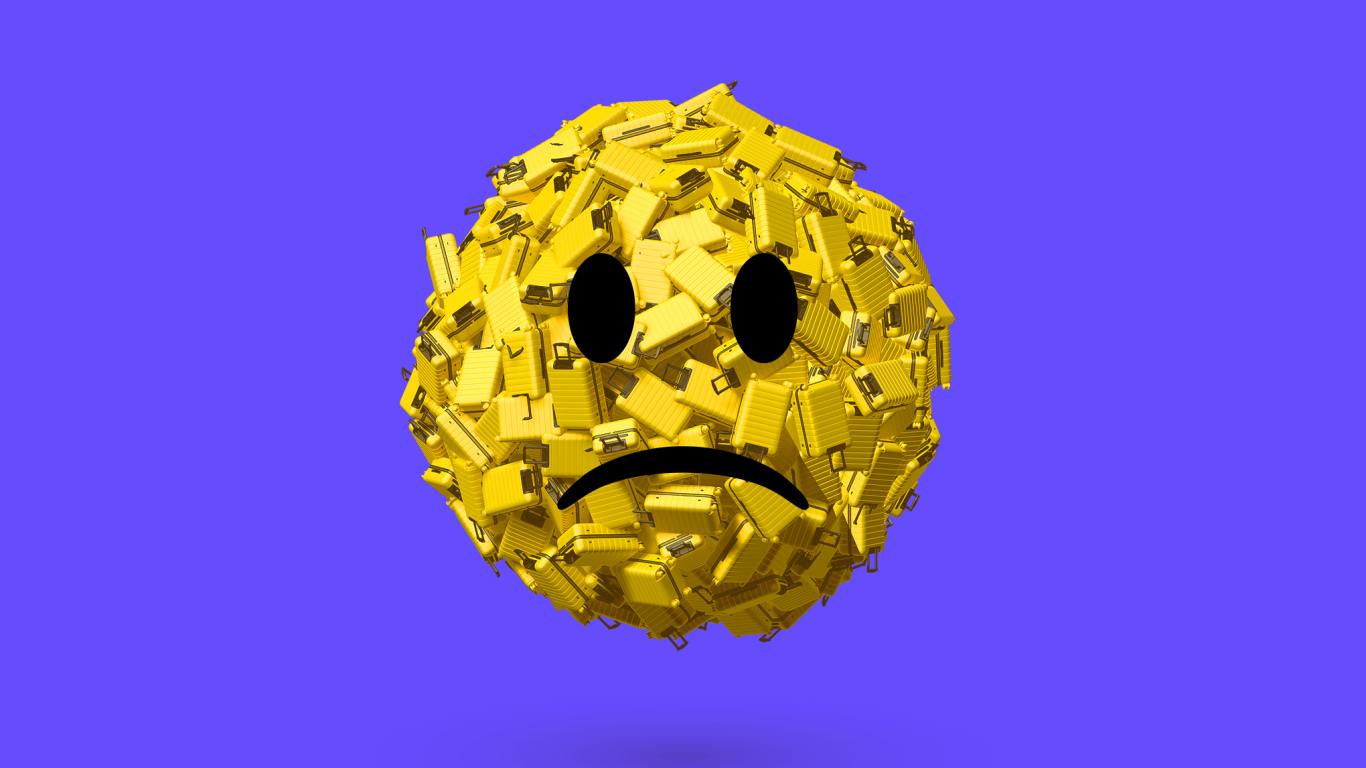 Грустный смайлик из чемоданов на синем фоне