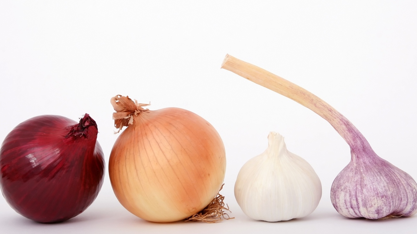 Репчатый лук с чесноком на белом фоне