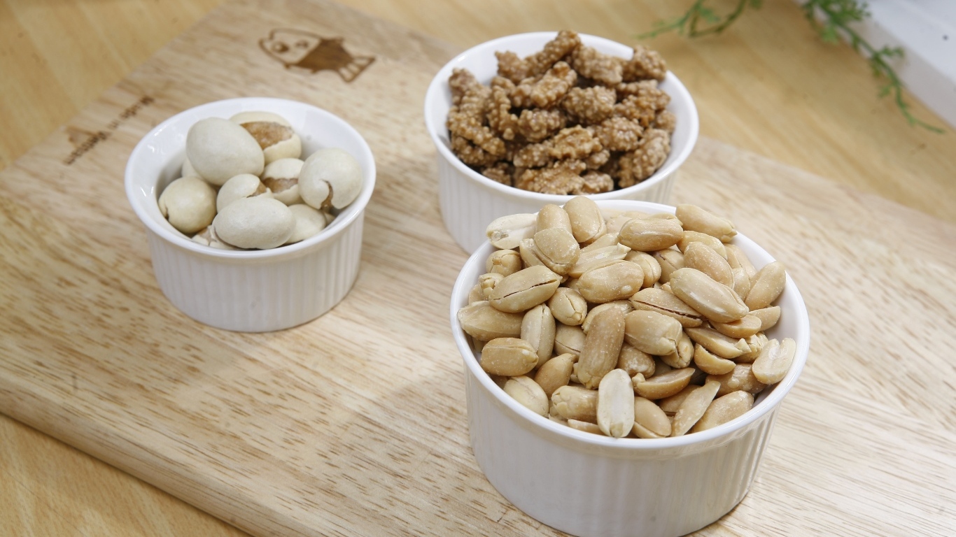 Орехи в белой посуде на доске