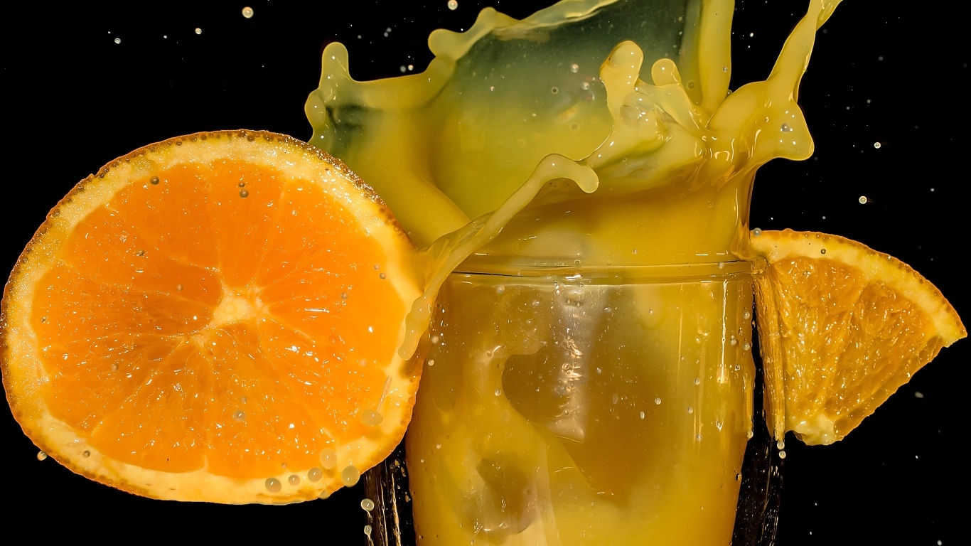 Свежий апельсиновый сок на черном фоне