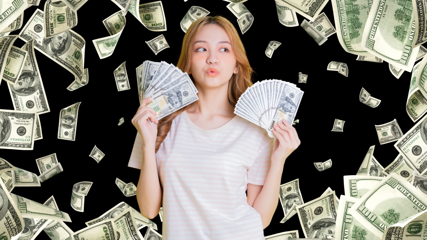 Девушка азиатка с долларами в руках