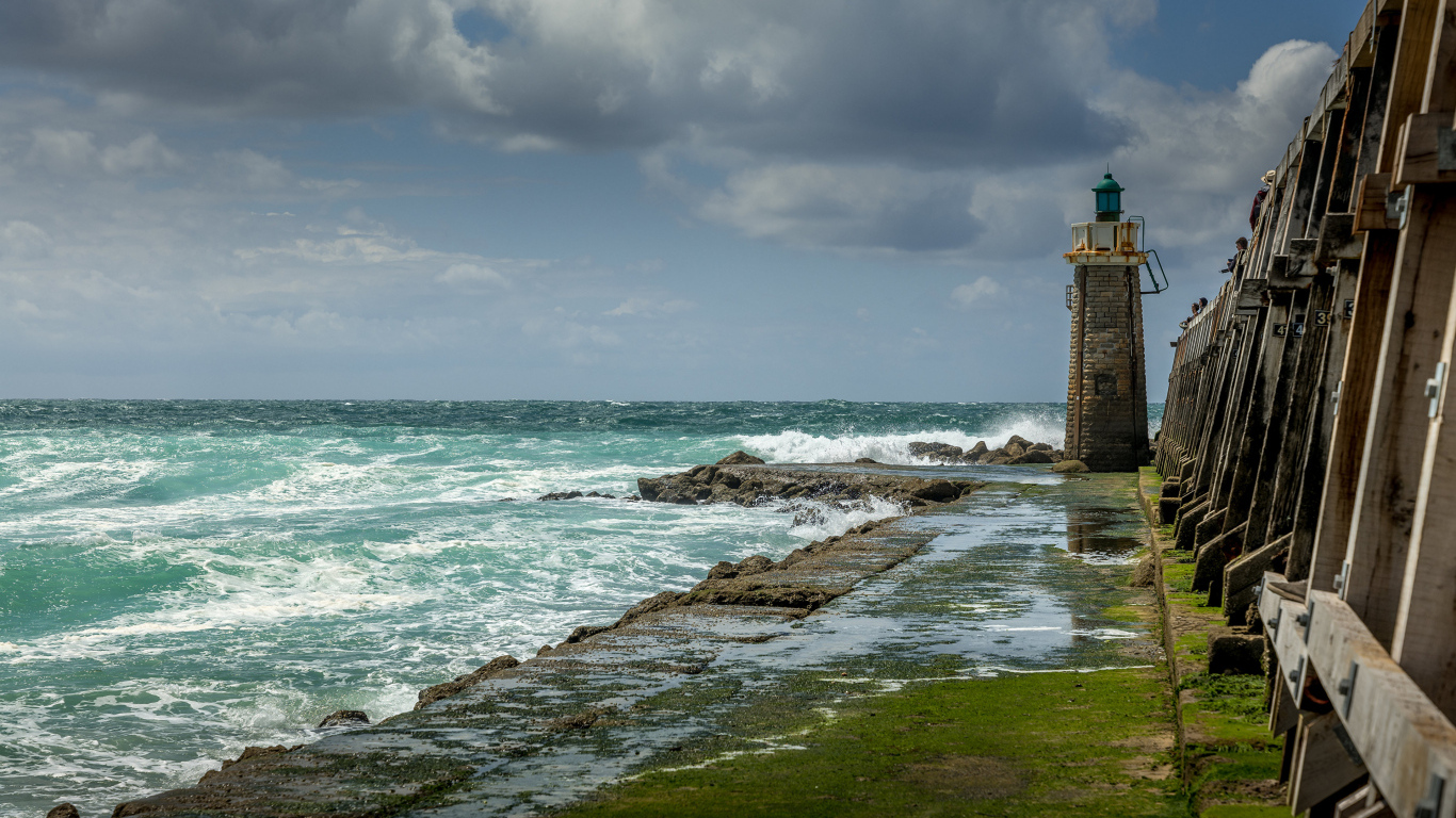 Lighthouse on the shore of the raging sea