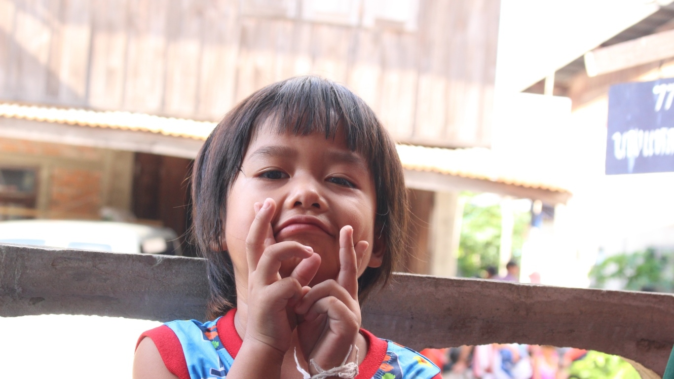 Девочка азиатка с руками  у лица