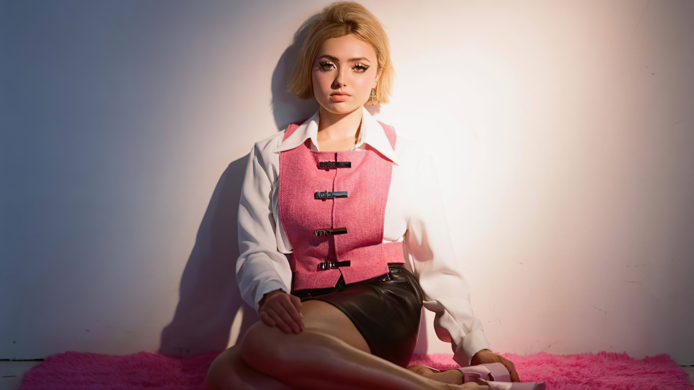 Молодая девушка Пейтон Рой Лист сидит у стены