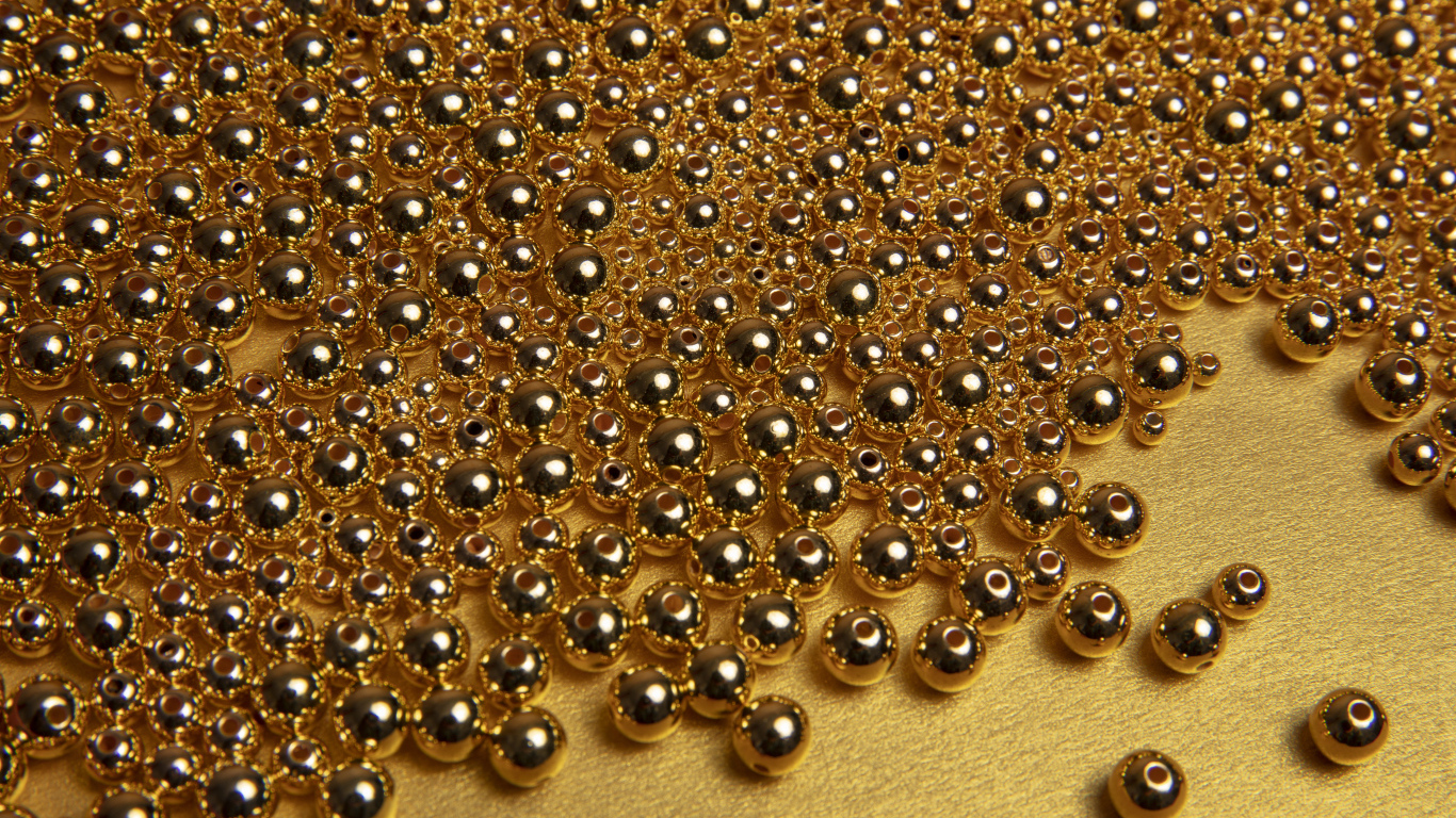 Много золотых бусин на желтом фоне