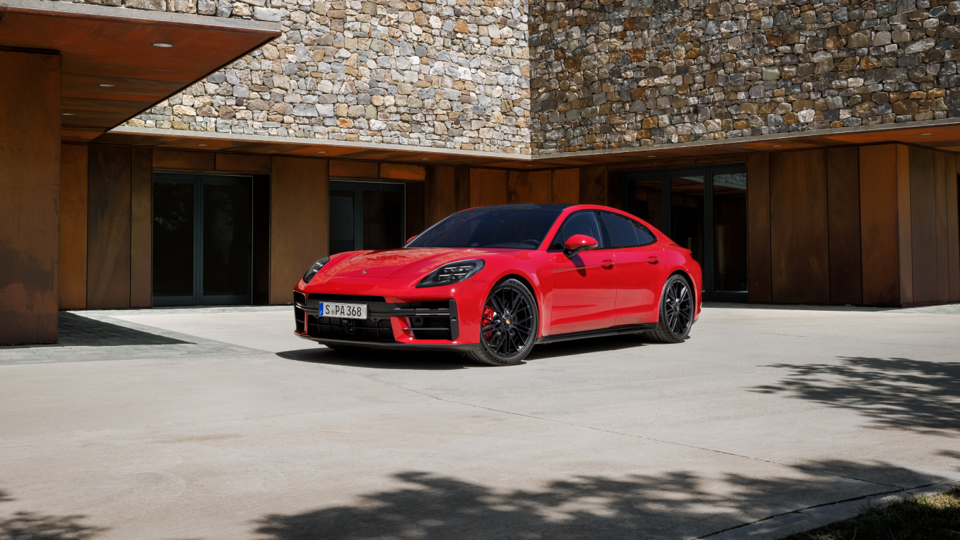Красный автомобиль Porsche Panamera GTS 2024 года у здания
