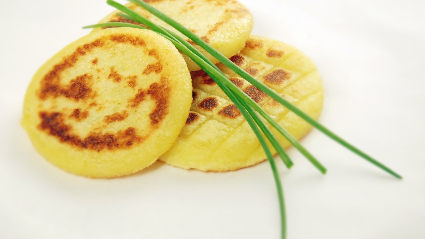 Картофельные оладьи с зеленом луком на столе