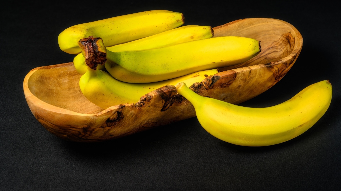 Деревянная чаша с бананами на столе