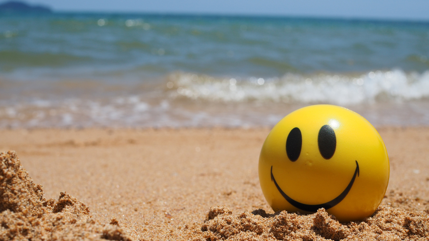 Улыбающийся смайлик на пляже у моря