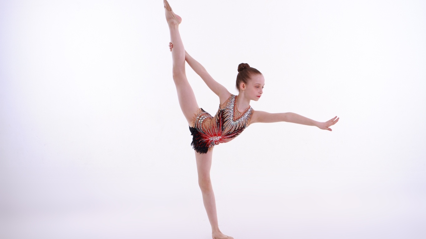 Девочка гимнастка делает упражнение