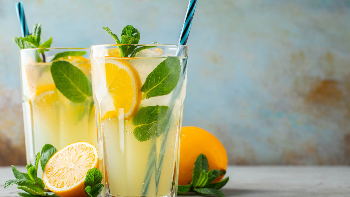 Два стакана лимонада на столе с лимоном