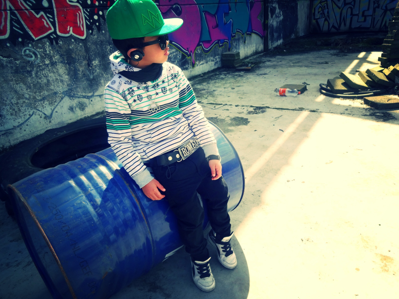 A boy in a green cap and barrel, swag