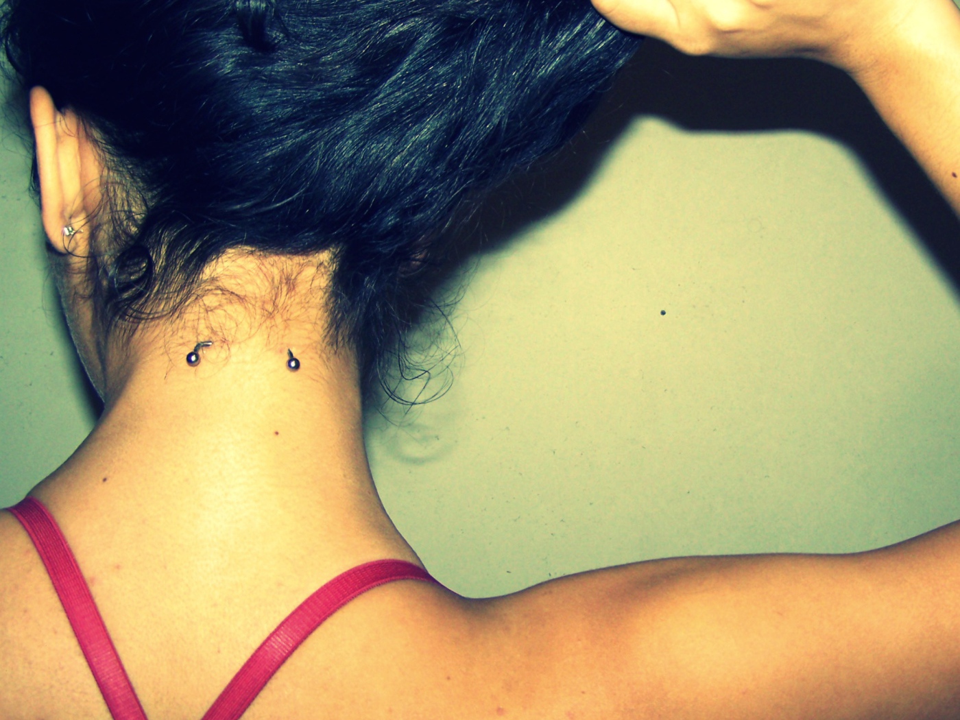 Девушка брюнетка с пирсингом в шее