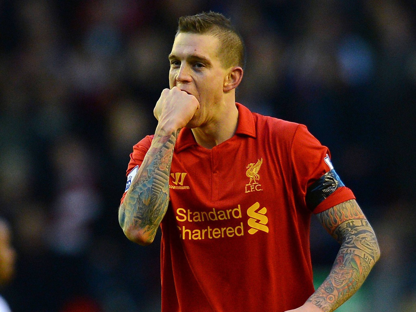 The player of Liverpool Daniel Agger is biting his fist