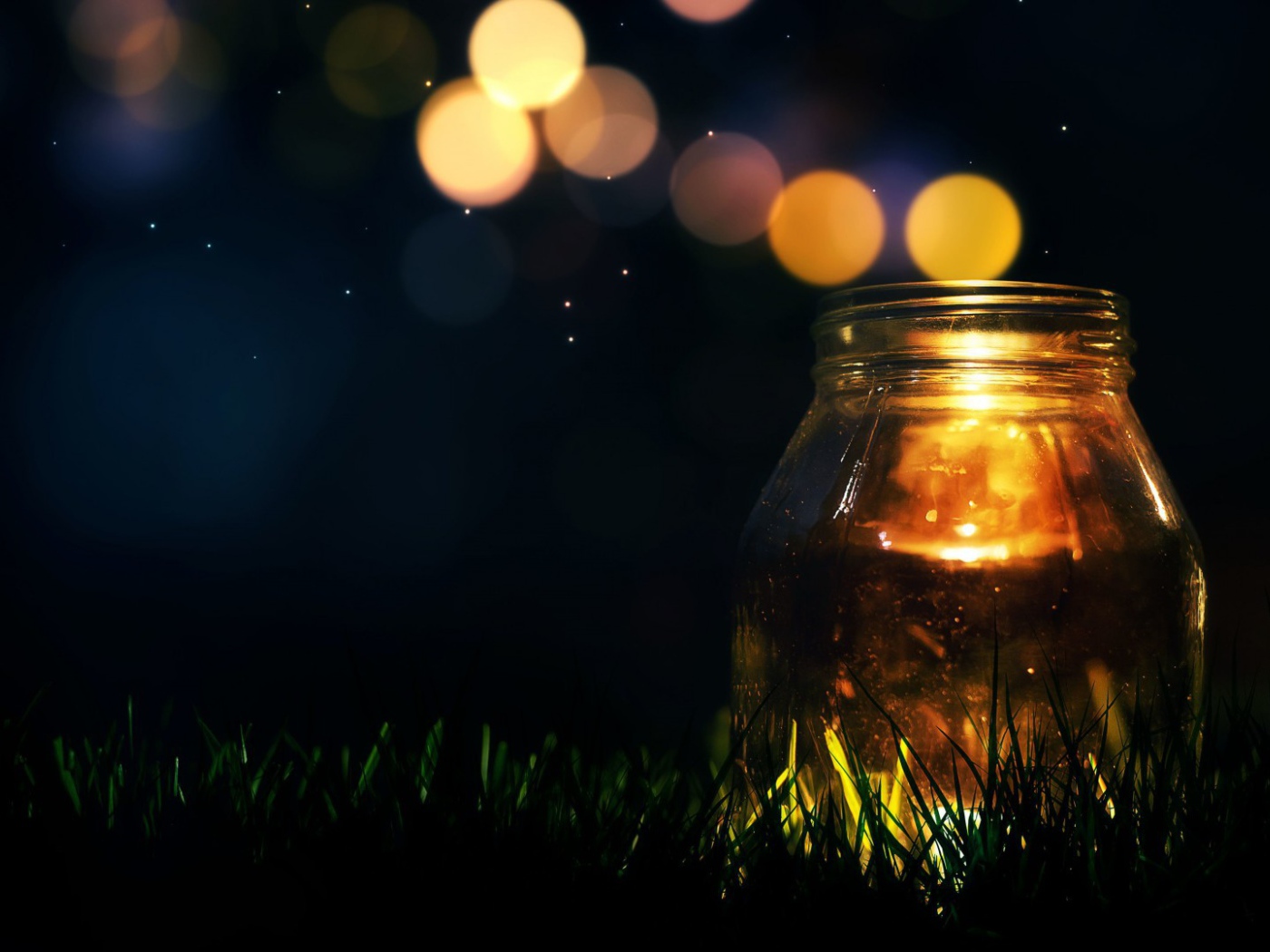 Glass jar on the grass at night
