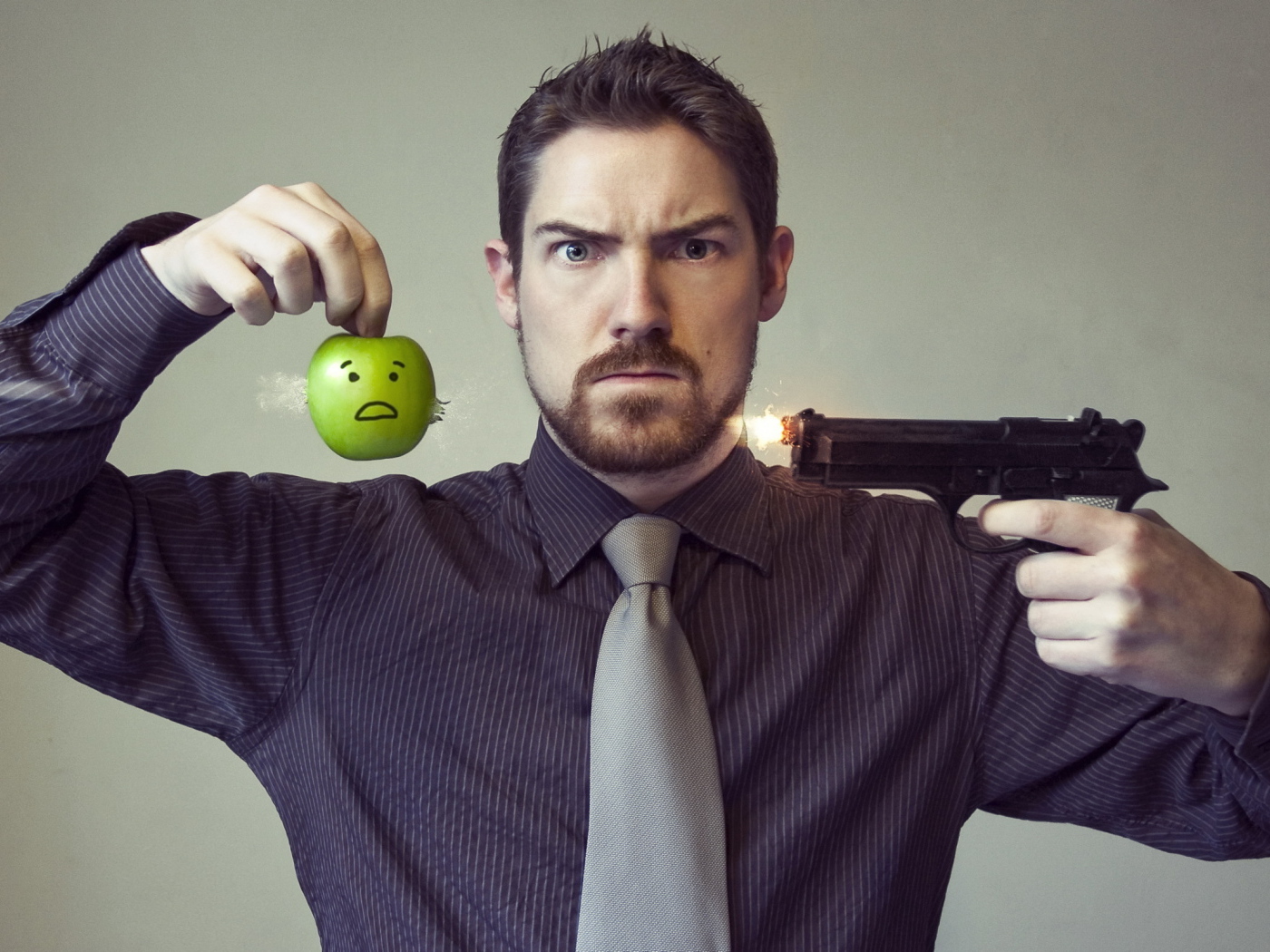 Мужчина стреляет в яблоко