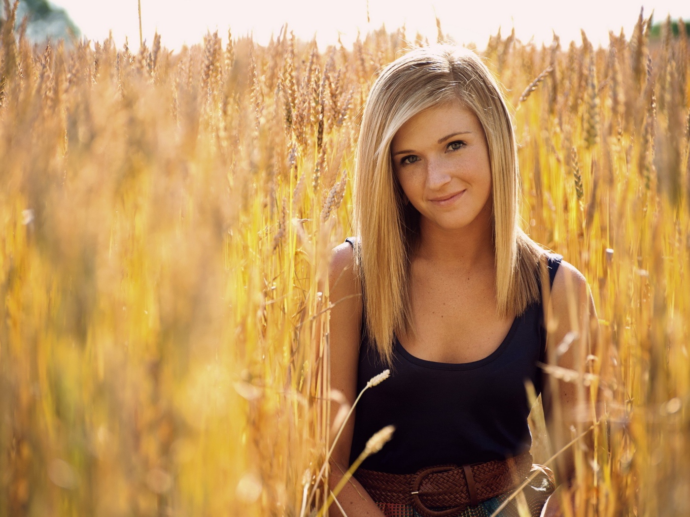 Девушка с веснушками среди пшеницы