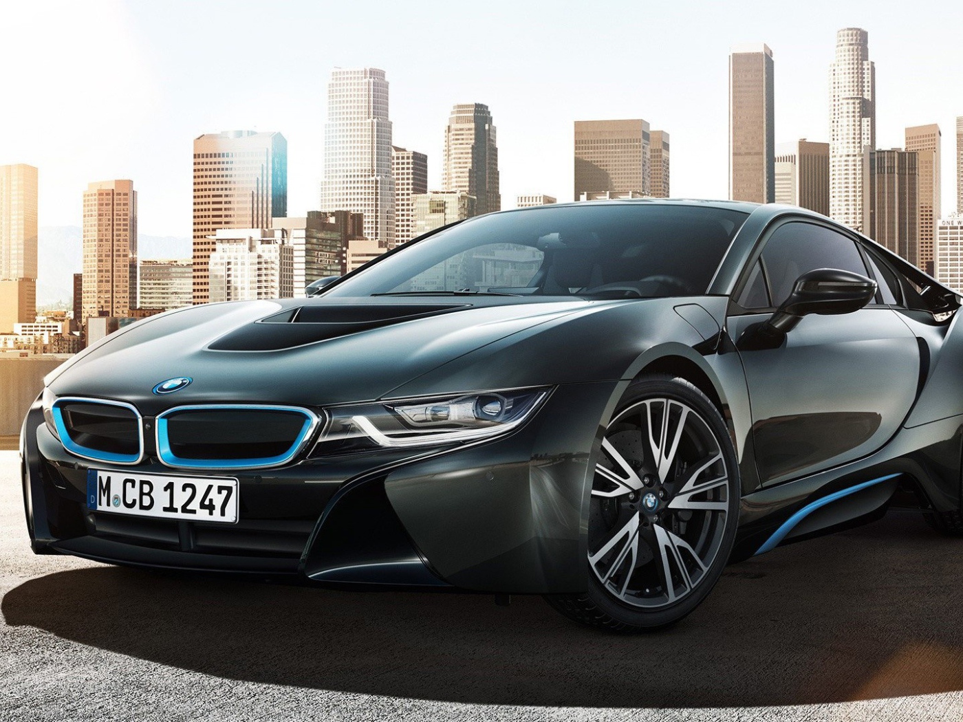 Спортивный черный БМВ на фоне мегаполиса