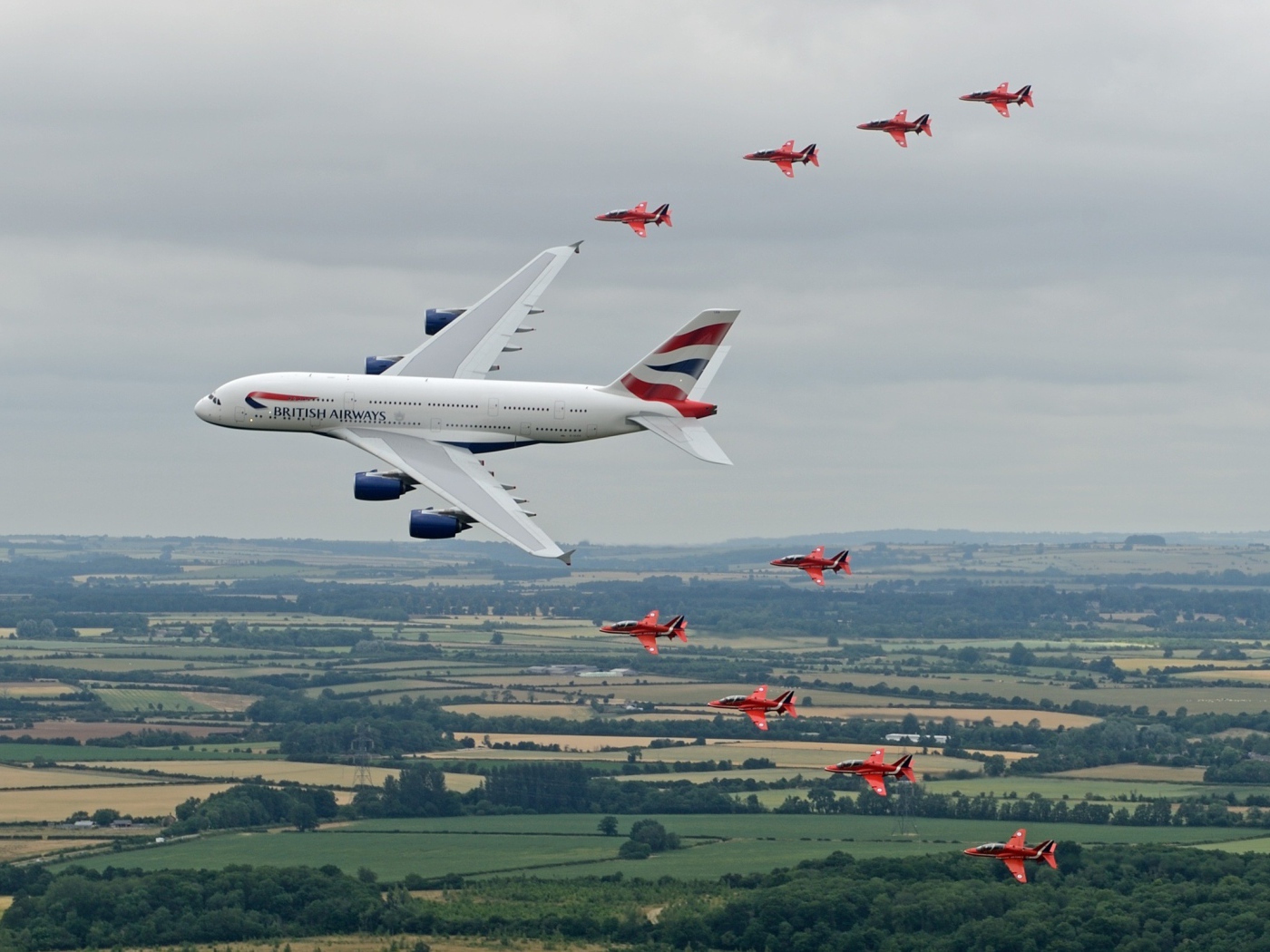 Airbus A380 в сопровождении красных истребителей