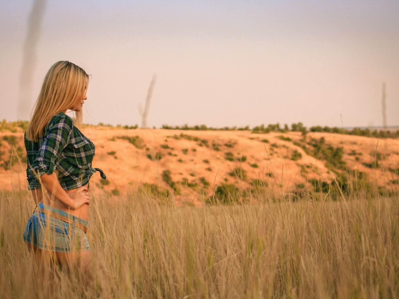 Girl in denim shorts walking in the field