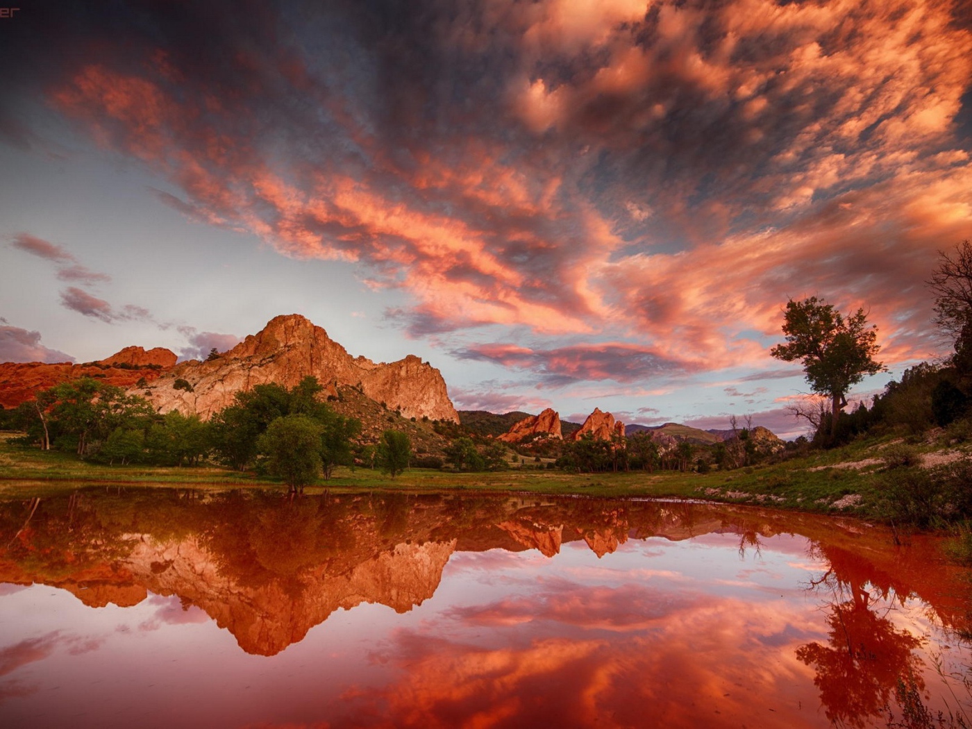 Облака отражаются в коричневой воде озера