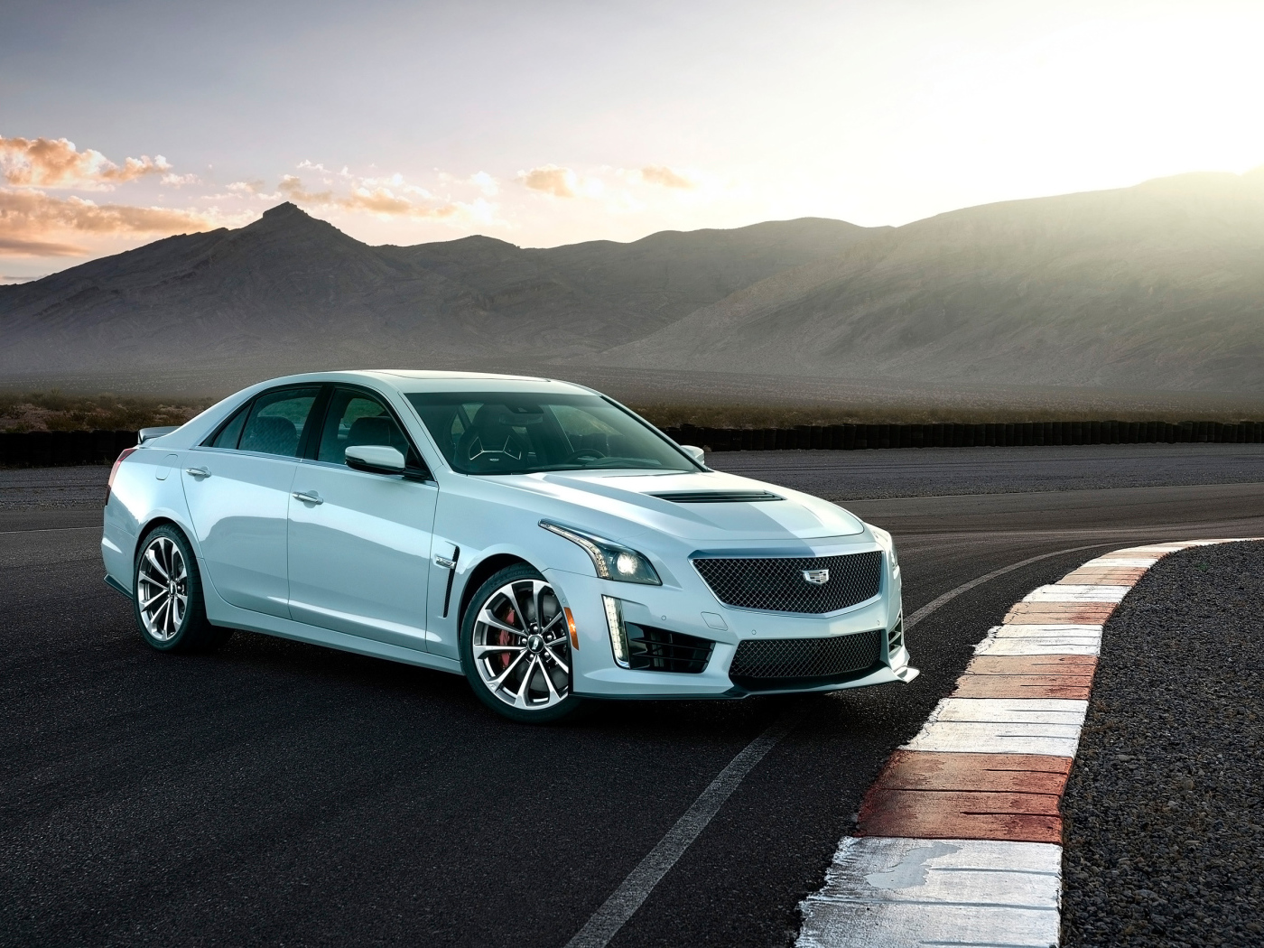 Белый автомобиль Cadillac CTS-V Glacier Metallic Edition, 2018 на фоне гор