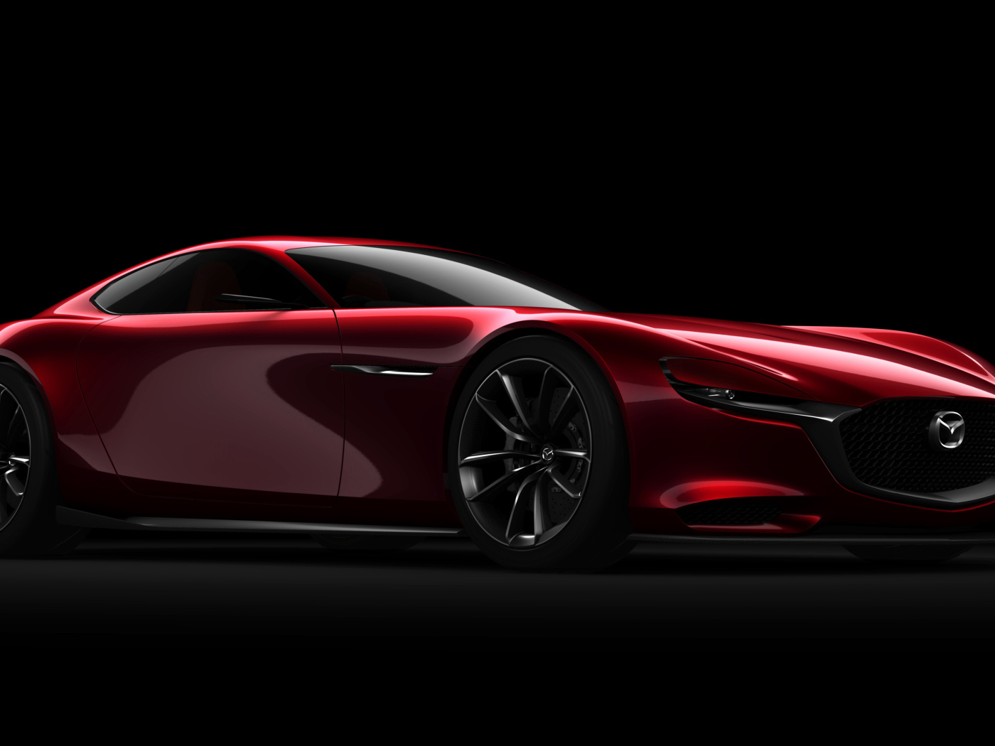 Красный спортивный автомобиль Mazda RX Vision Concept на черном фоне