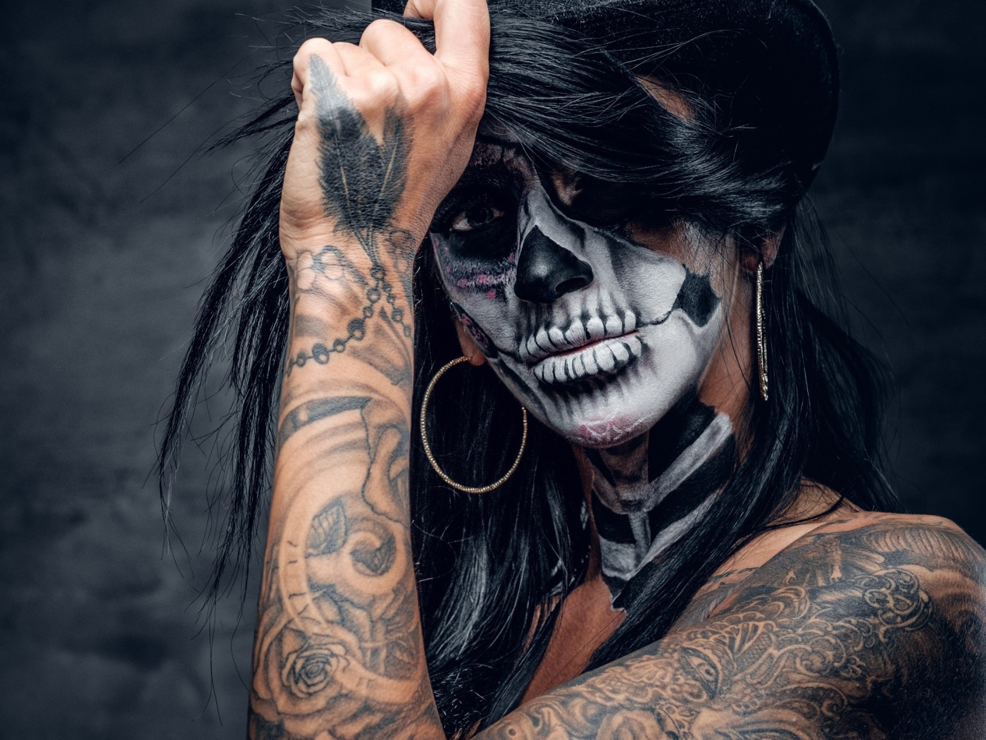 Brunette with tattoos and makeup on her face