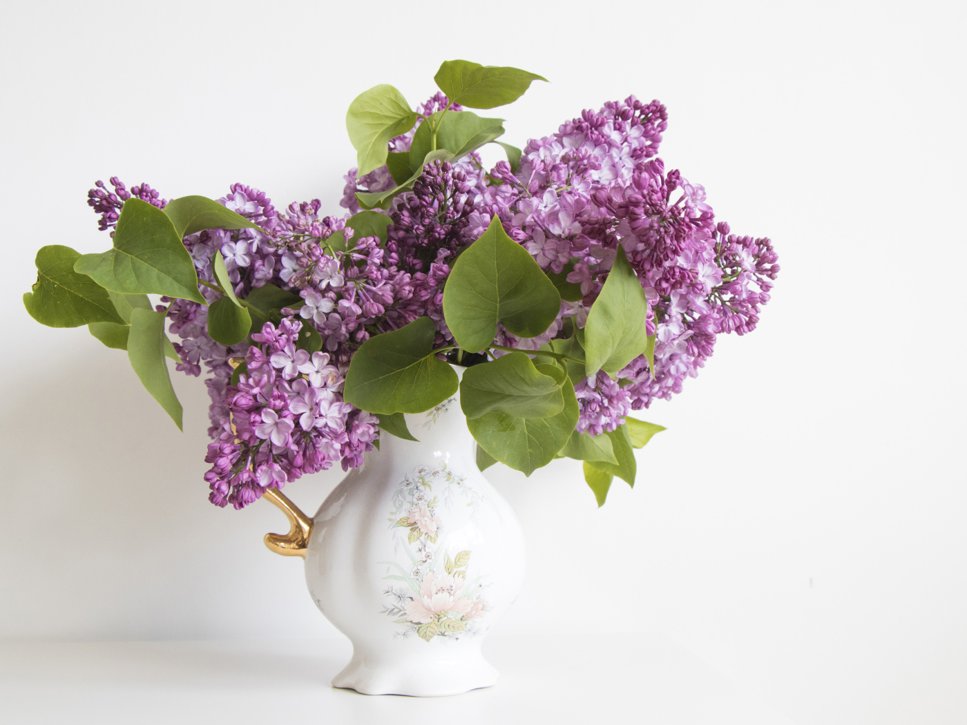 Букет сирени в красивой вазе на белом фоне
