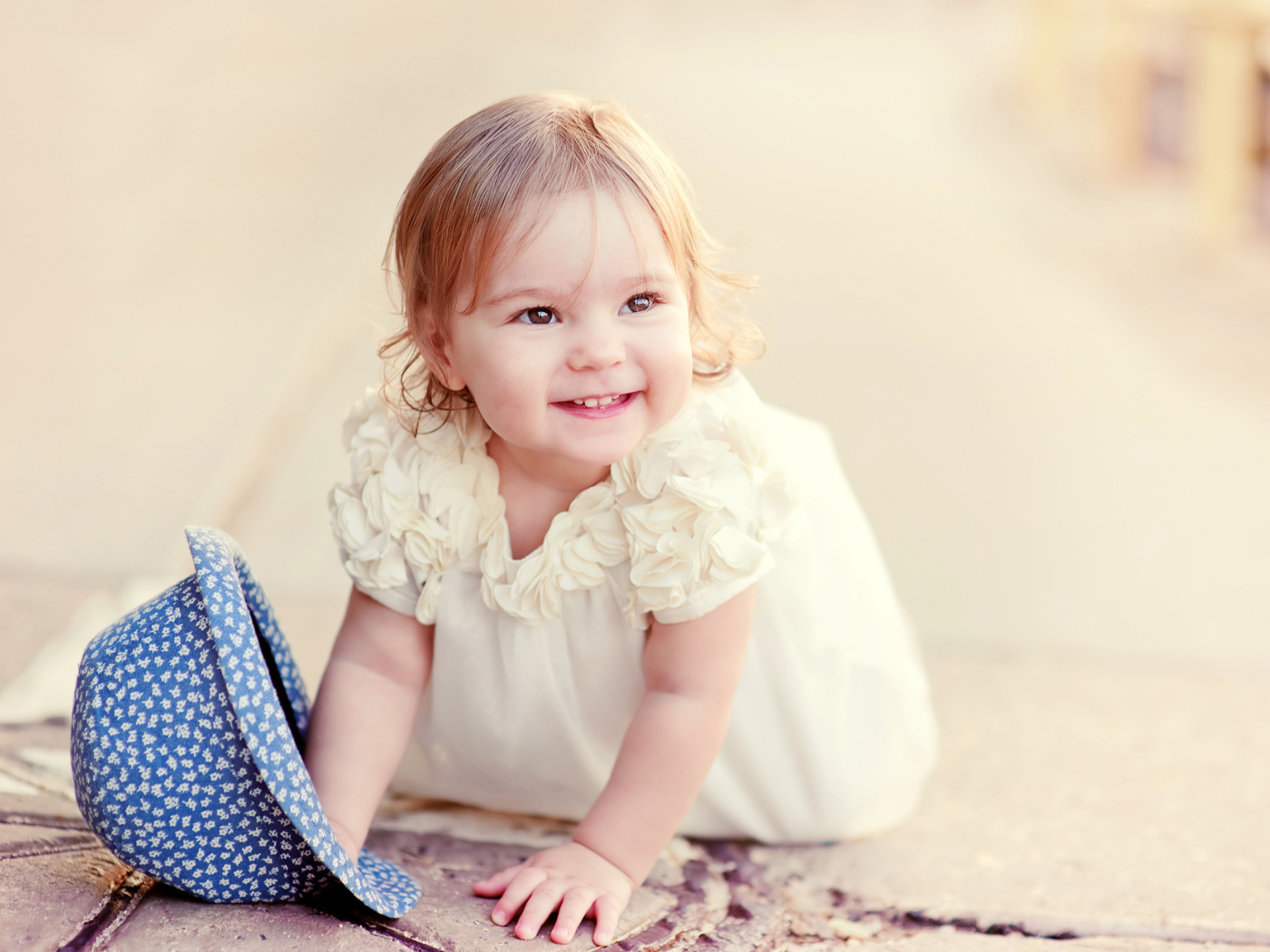 Милая улыбающаяся девочка в белом платье