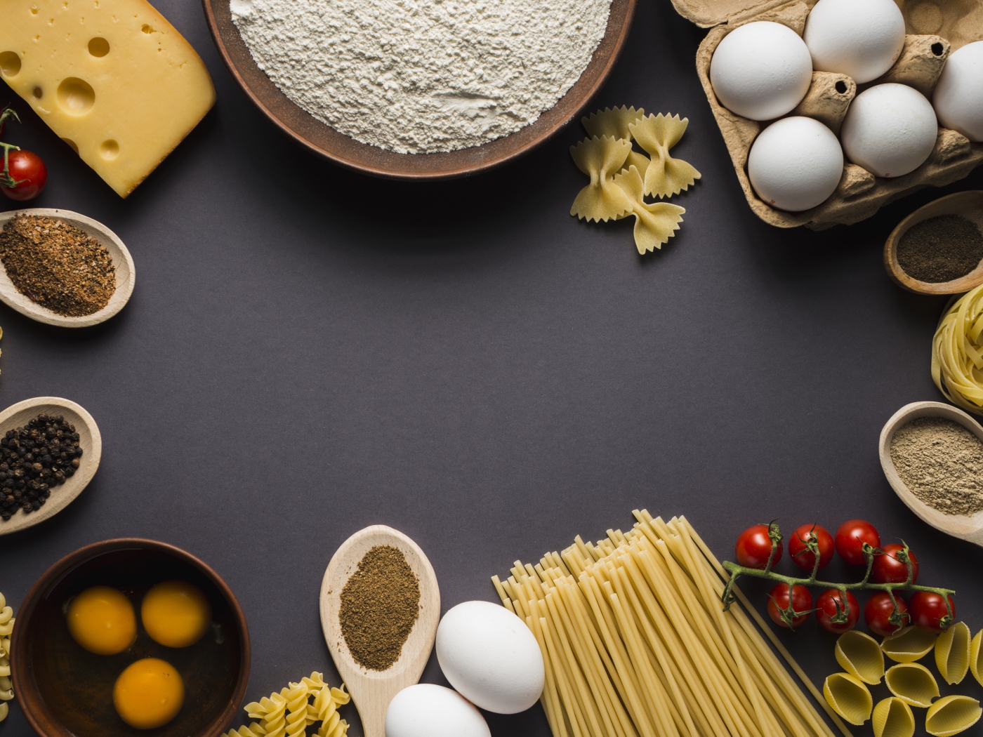 Паста, яйца, специи и помидоры на сером фоне