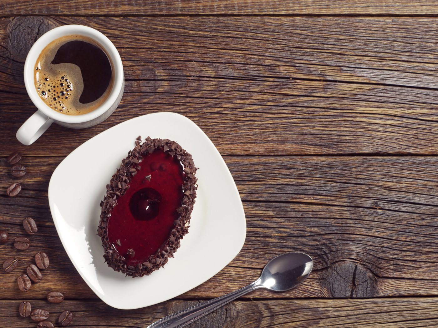 Пирожное с шоколадом на деревянном столе с чашкой кофе