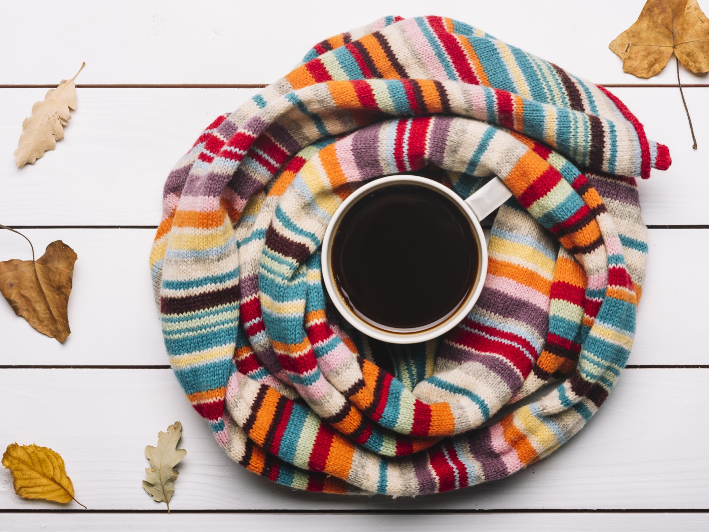 Чашка горячего шоколада на столе с вязаным шарфом