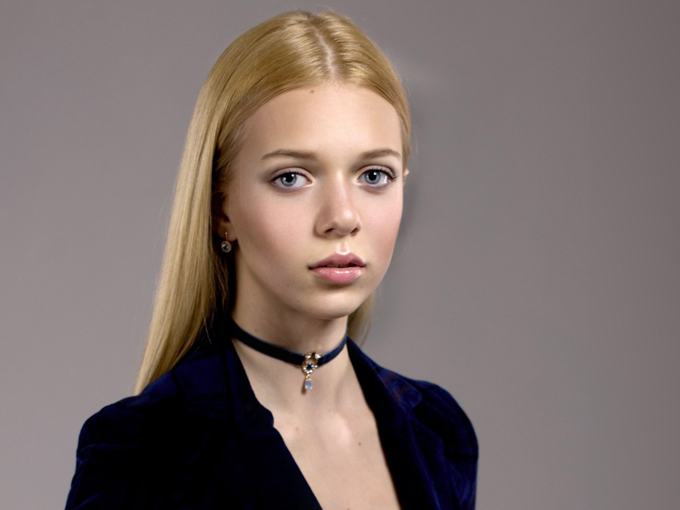 Нежная голубоглазая девушка с украшением на шее 