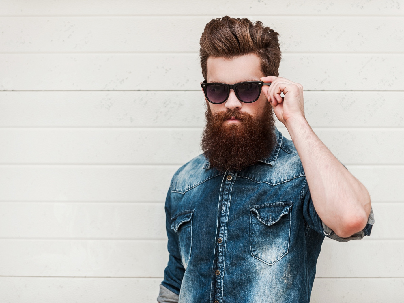 Handsome man with a beard in black glasses