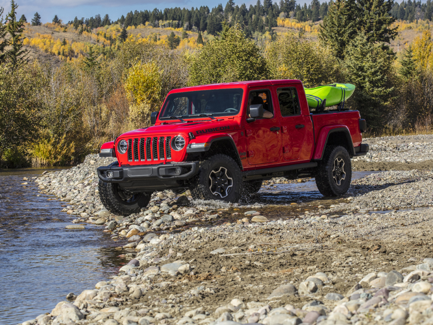 Красный пикап Jeep Gladiator Rubicon, 2020 года у реки