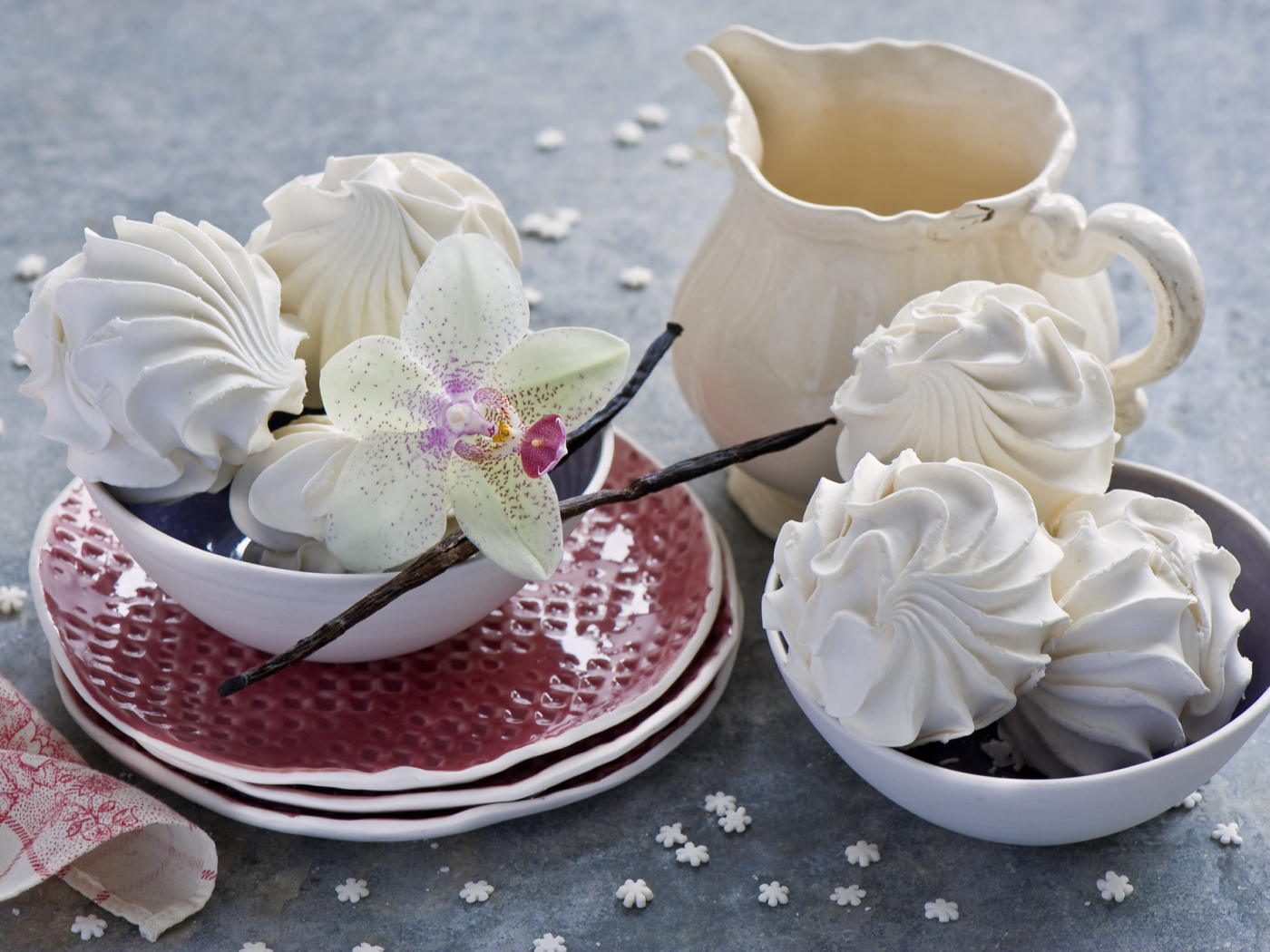 Белый зефир на столе с цветком орхидеи