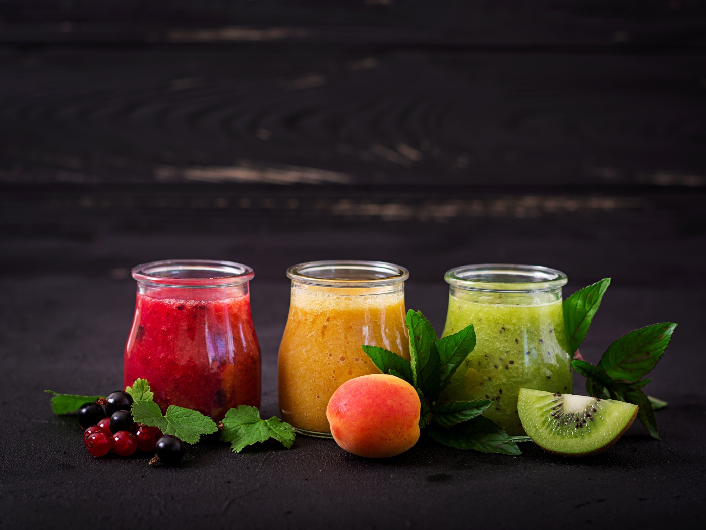 Фруктовое смузи в баночках на столе 