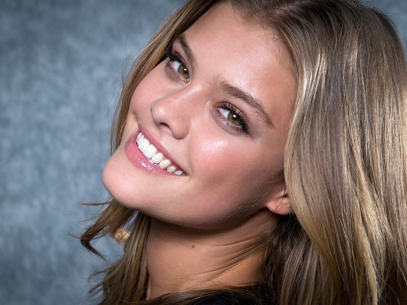 Smiling model Nina Agdal face close-up.
