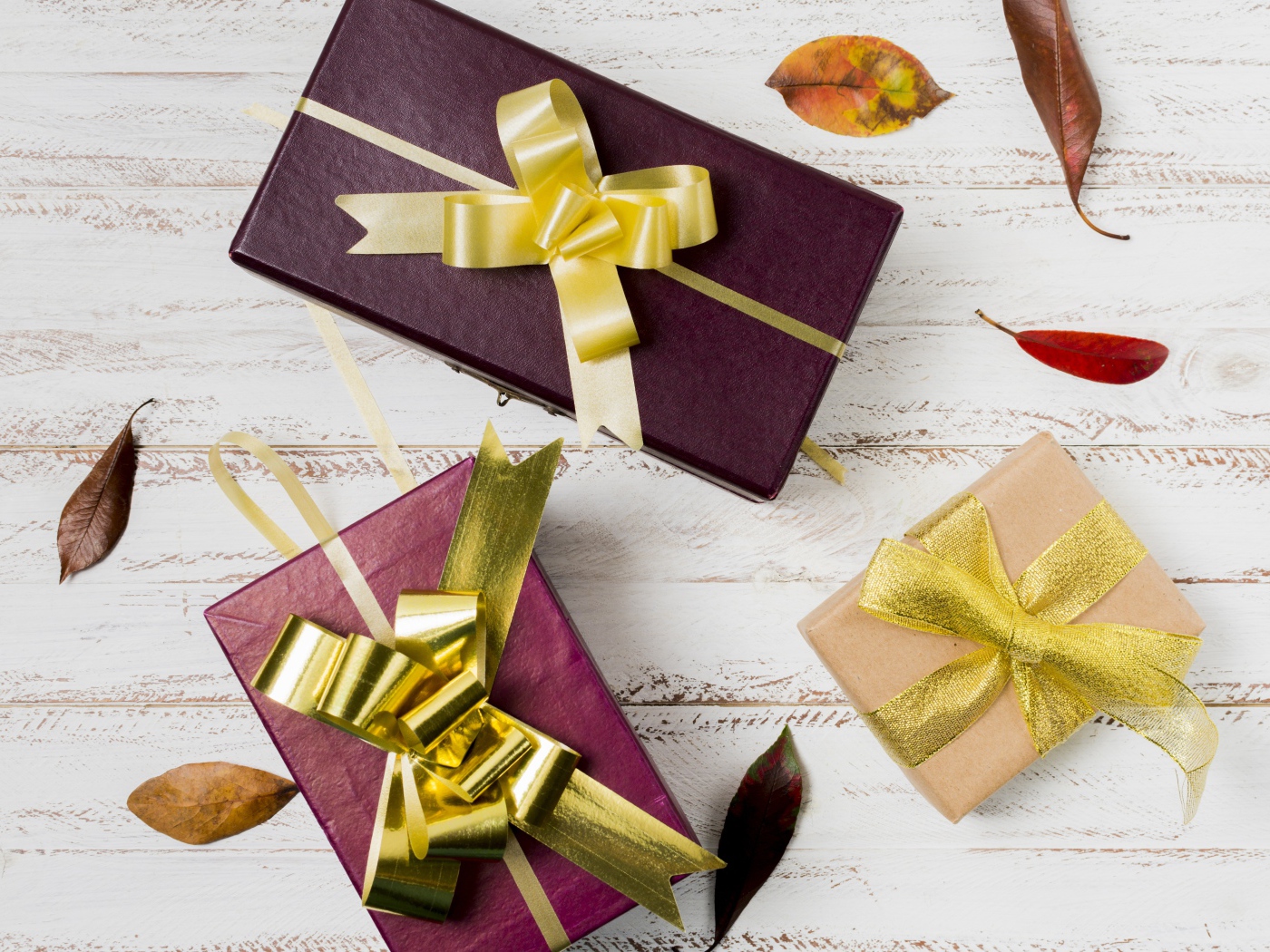 Three gift boxes with bows on the table